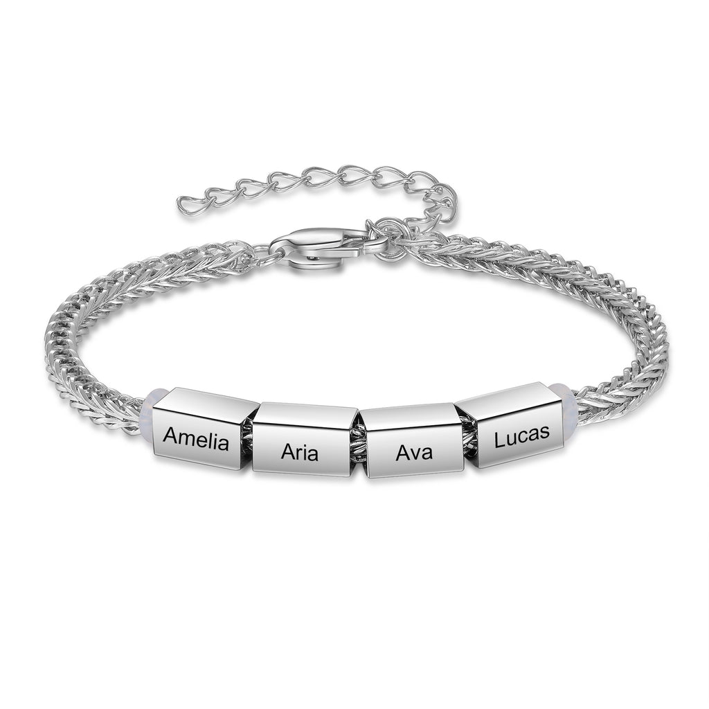 Silver family name bracelet with four engraved charms reading Amelia, Aria, Ava, and Lucas