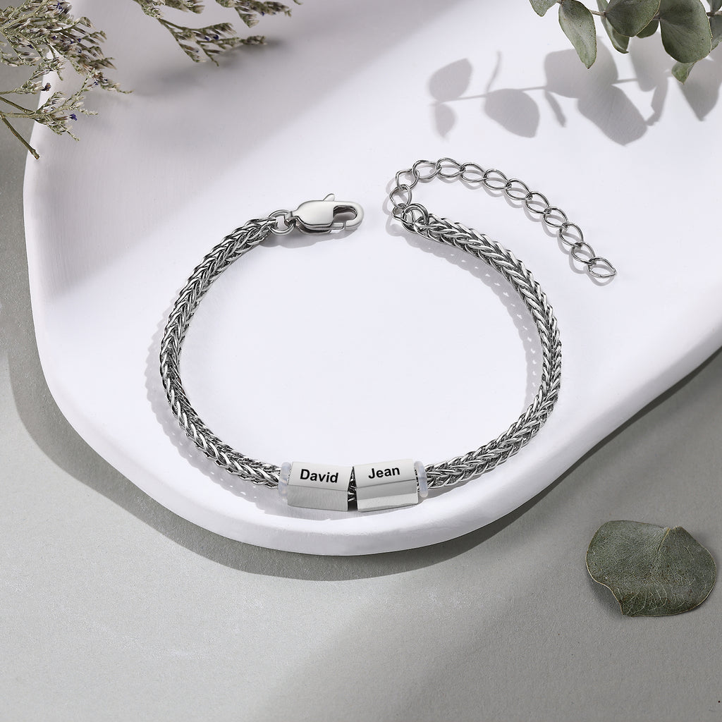 Silver wheat-chain family bracelet with two engraved name charms reading David and Jean
