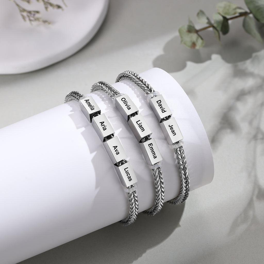 Three silver wheat-chain family bracelets with two, three, and four engraved name charms shown side by side